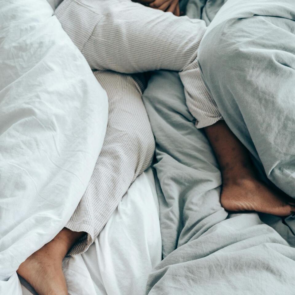 Person with restless legs in bed